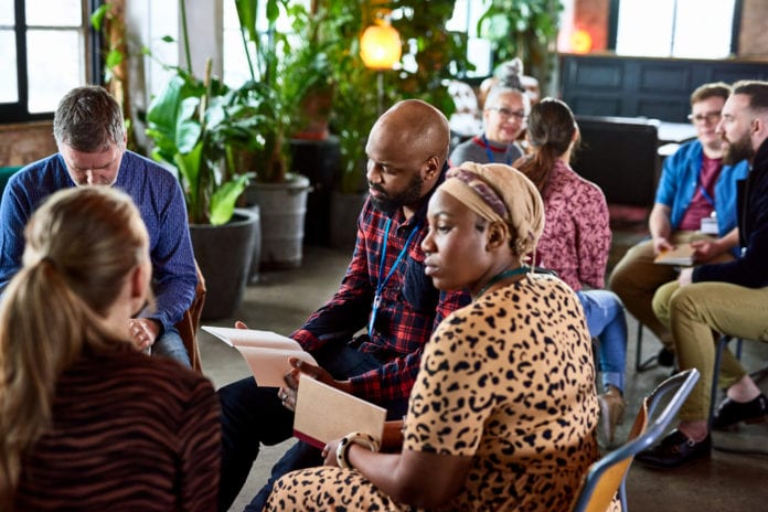 Workers Sitting in Small Groups