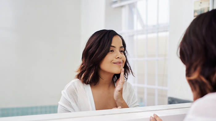 Woman looking at her self on a mirror