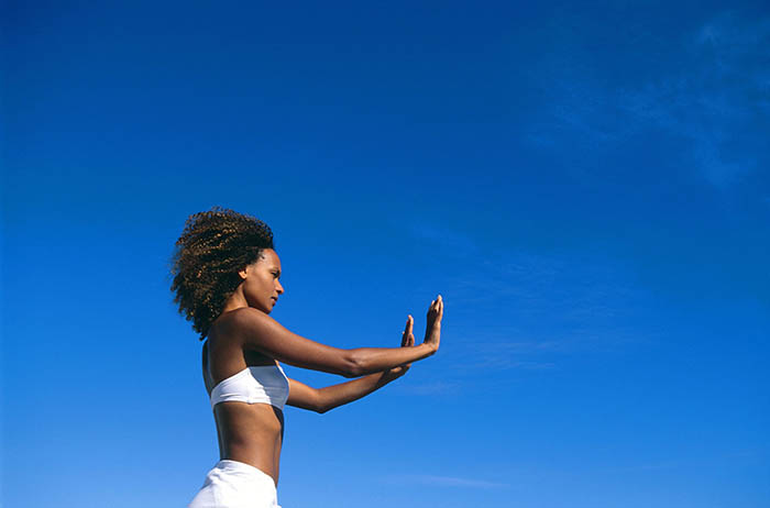 woman practicing tai chi outdoors