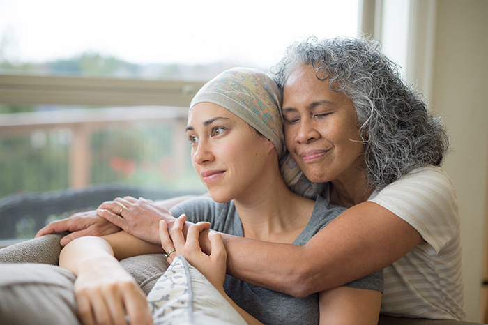 mother hugging cancer patient daughter
