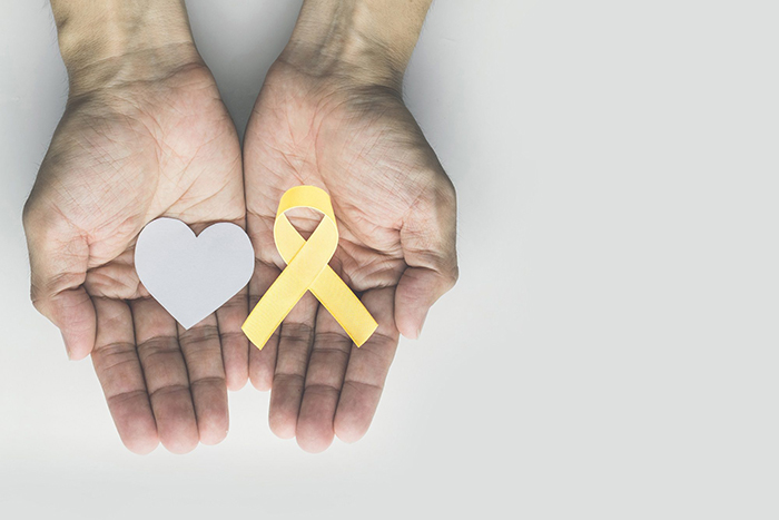 hands holding heart health awareness ribbon and heart shape