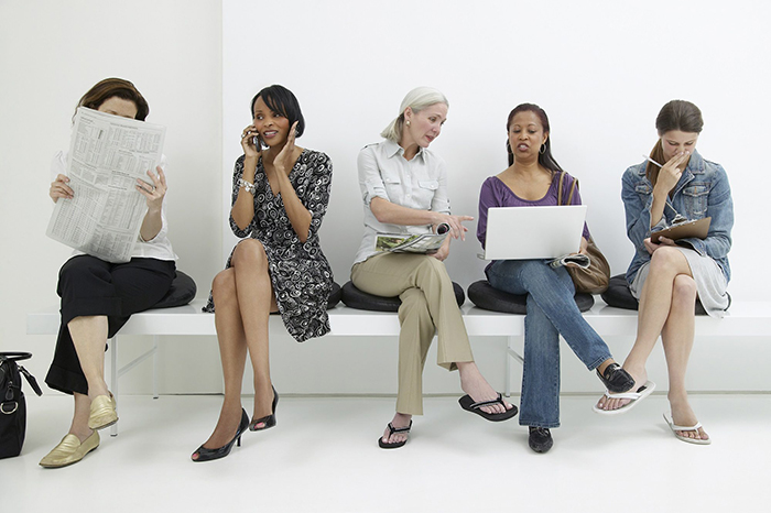 Women sitting in a doctors office and waiting