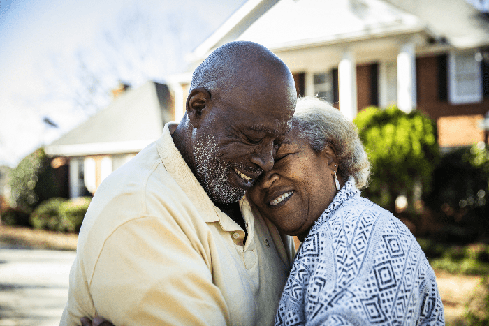 senior couple embraces and smiles