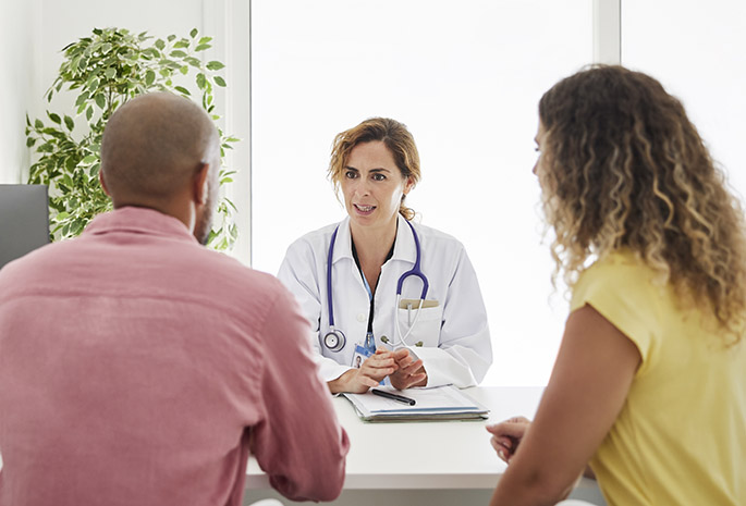 doctor discusses clinical trials with patients