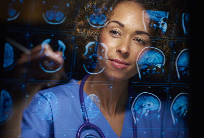 Oncologist looks at brain cancer scans