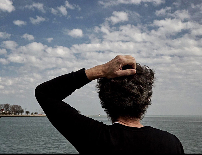 man looks out at ocean