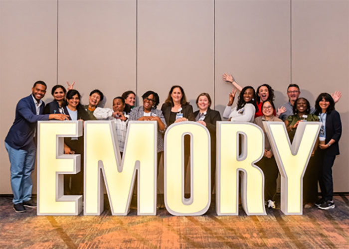 Emory Healthcare Careers event, employees standing behind huge Emory sign