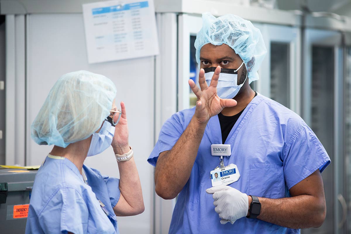 two emory nurses having a discussion in an operating room 