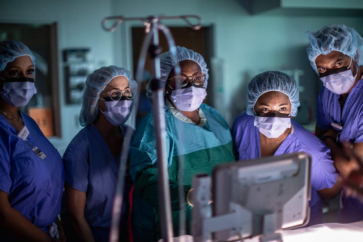 Group of nurses in OR room preparing for surgery.