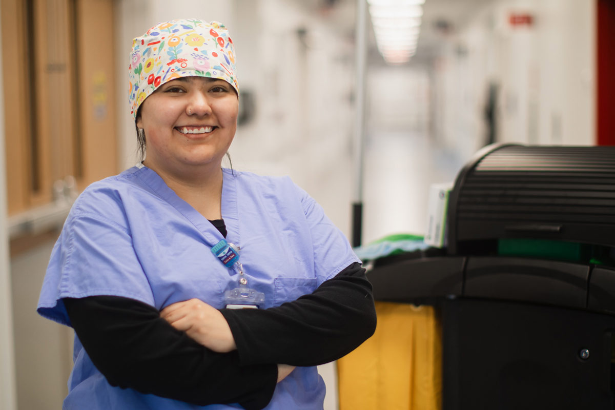 environmental services employee in a hospital hallway