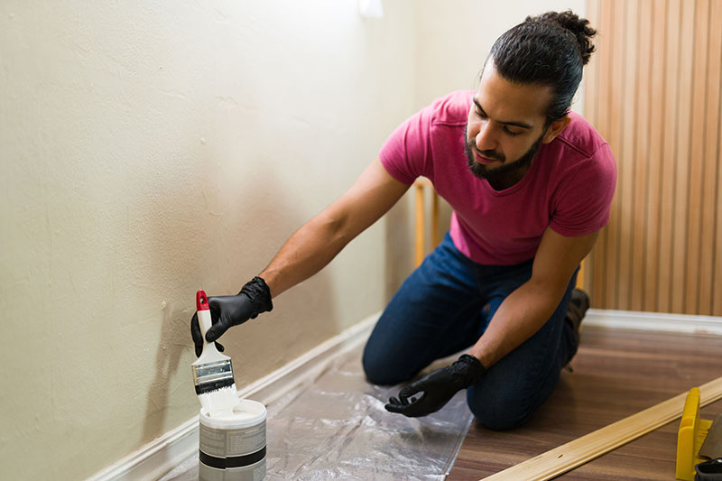 man painting his wall