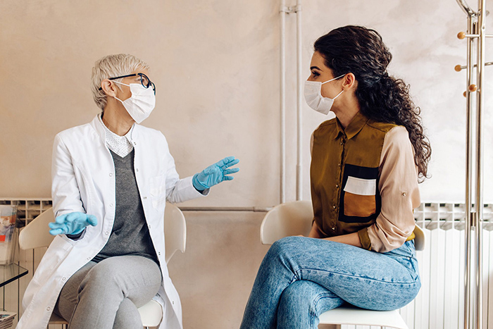 Female doctor talking to patient