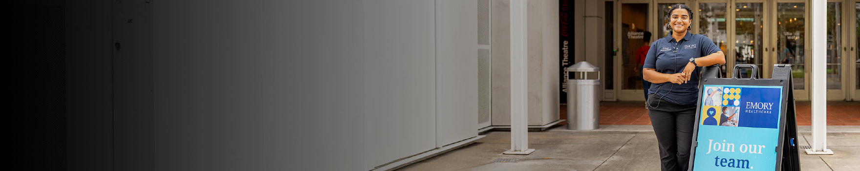 Employee in front of hospital entrance