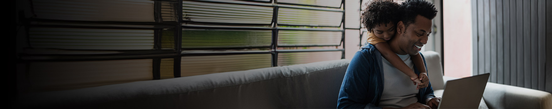 Man on computer with kid