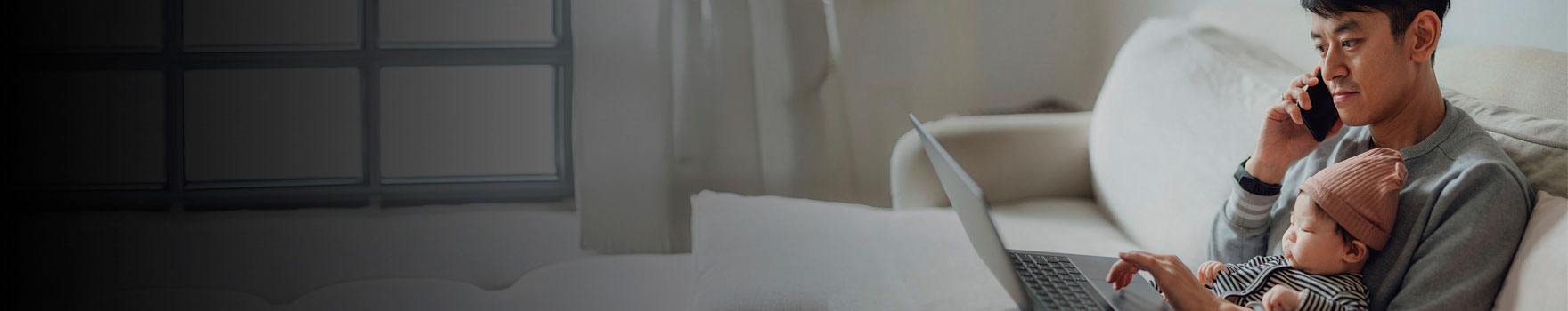 Man talking on the phone holding a baby