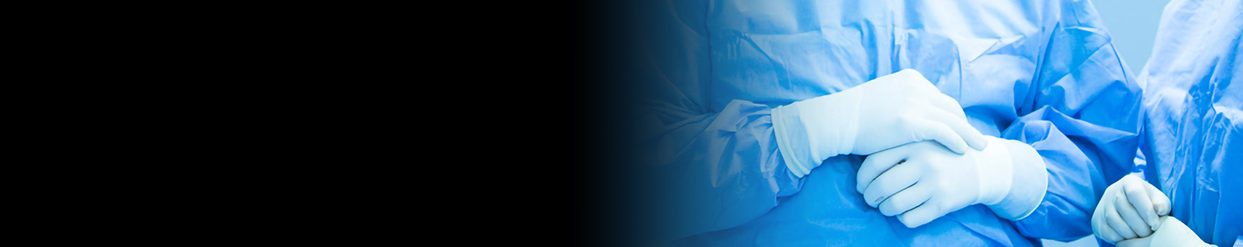 surgeons in scrubs and surgical gloves