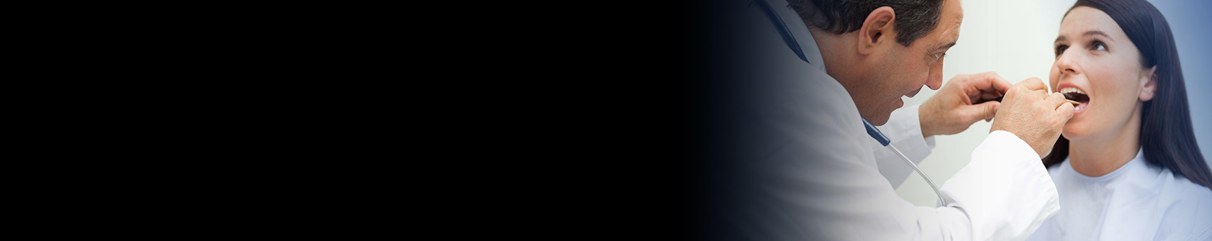 doctor looking inside woman's mouth