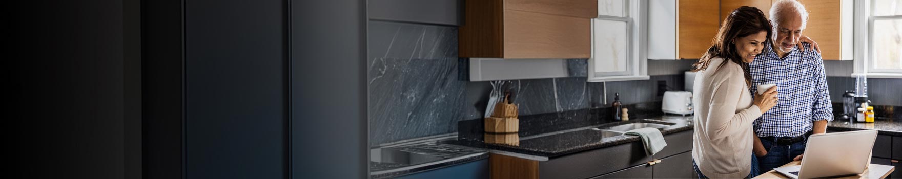 Couple reviewing financial information on a laptop together