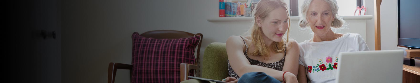 Women watching a movie on a laptop while lounging