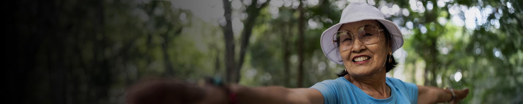 woman wearing large glasses stretching outdoors