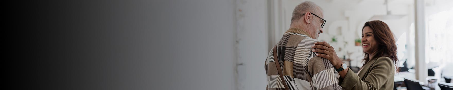 elderly man wearing glasses with young woman