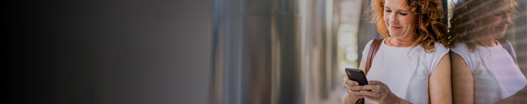 Woman checking her phone with a casual smile