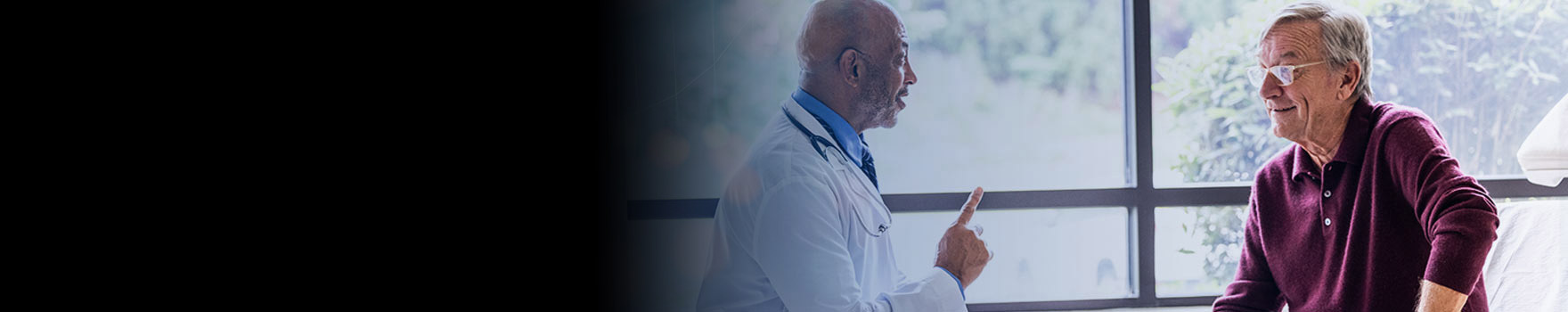 elderly man speaking with his doctor