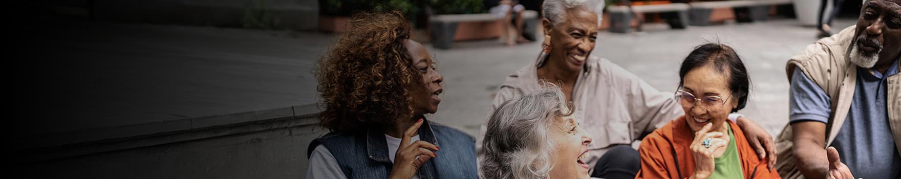 older people in conversation laughing