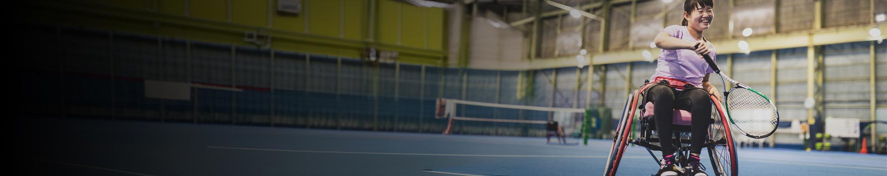 woman in wheelchair playing badminton