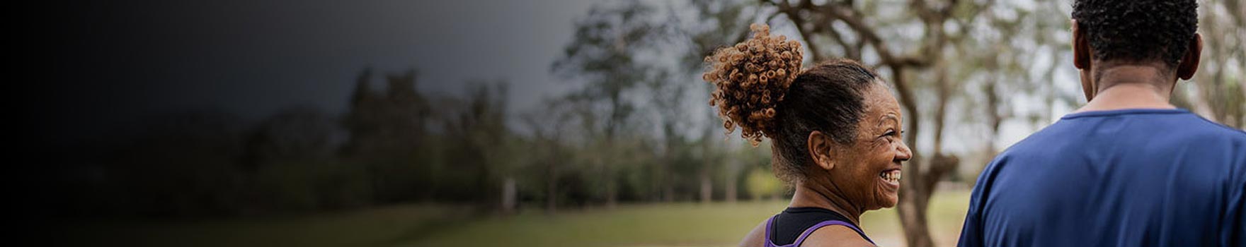 woman laughing with walking outdoors with a man