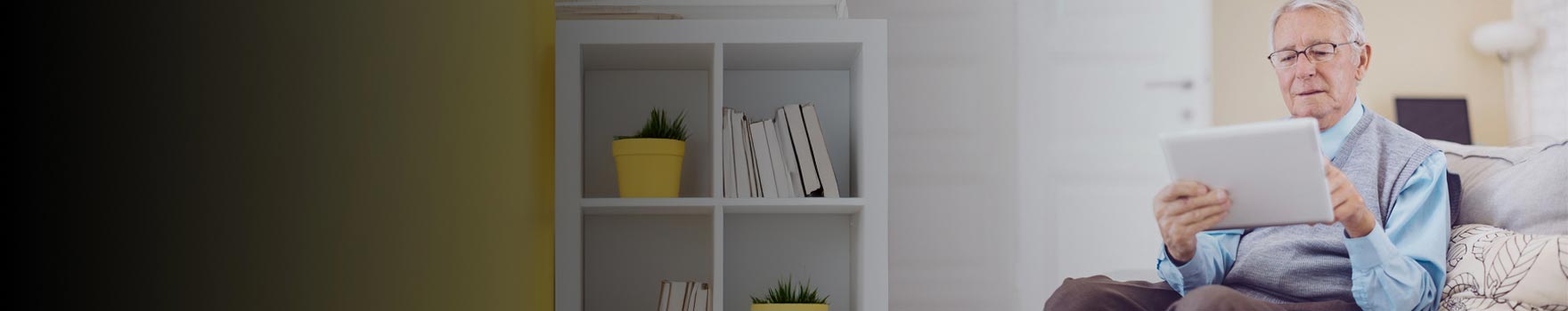 Older man browsing information on his tablet