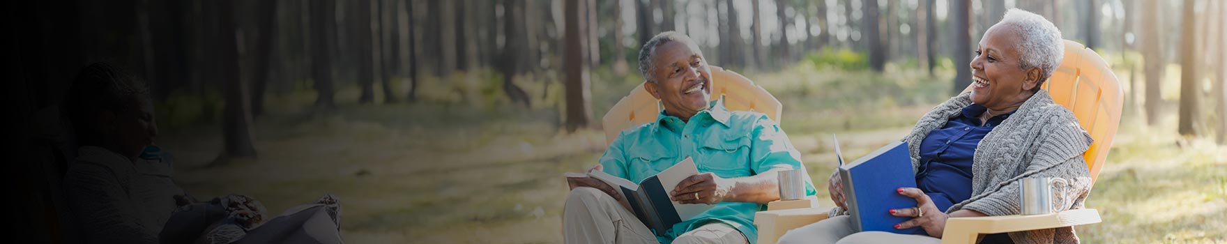 An older couple reading outdoors