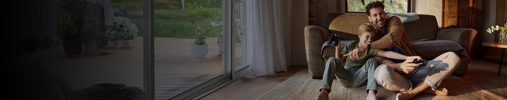 A young dad and his son laughing and playing together in the living room
