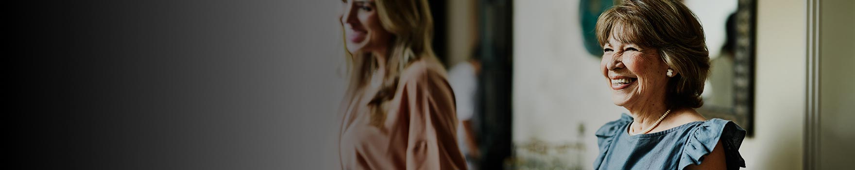 Two women smiling in the living room
