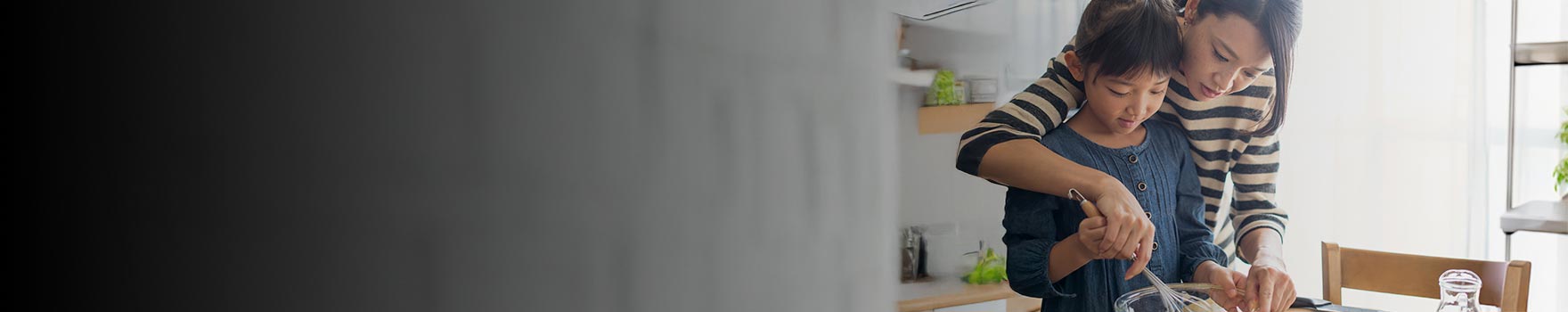 Mother and daughter cooking together in a kitchen