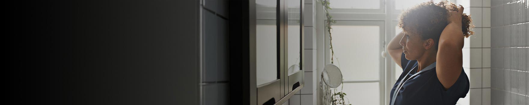 A young woman getting ready in the bathroom