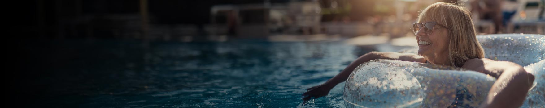 An older woman enjoying her time inside a pool