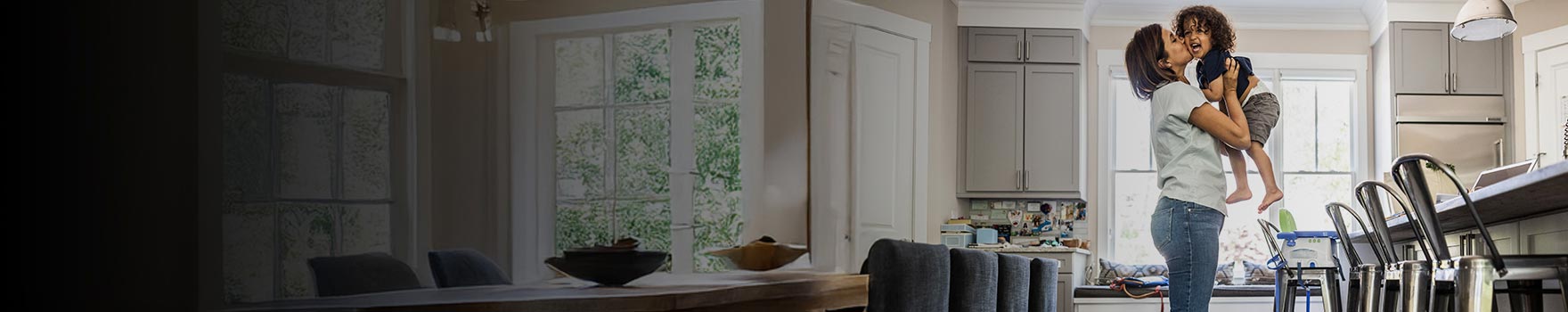 A mother holding her son and kissing him