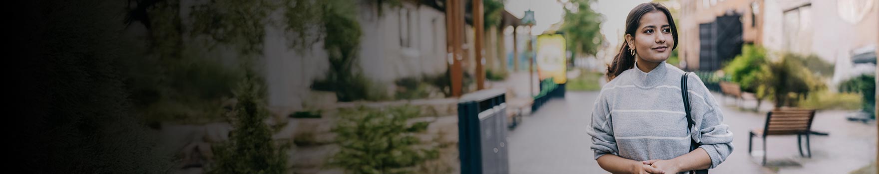 A young adult woman walking at an outdoor mall