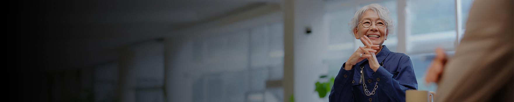 An older asian woman talking to a friend