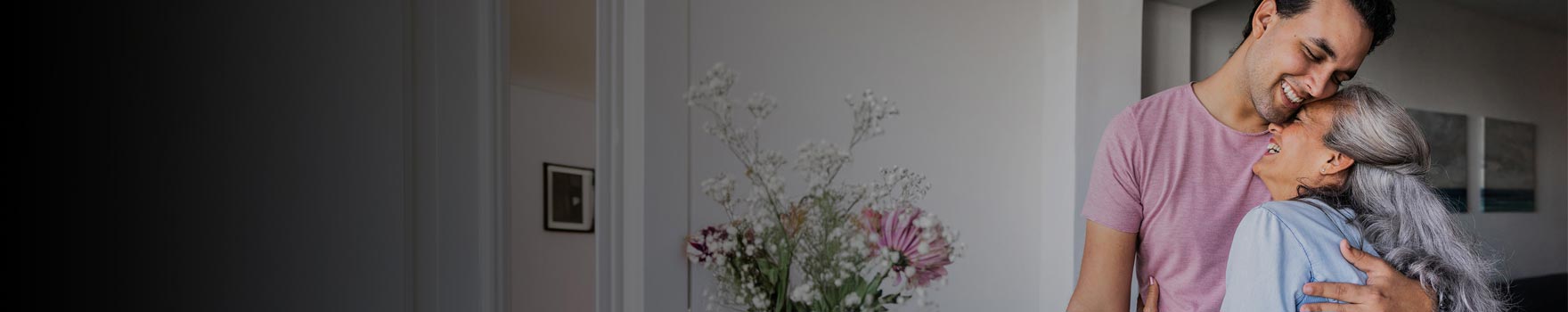 Mother and son hugging and laughing together