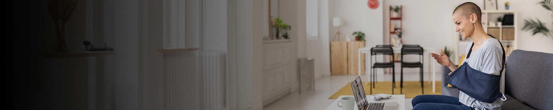 Injured person meeting with physician on laptop