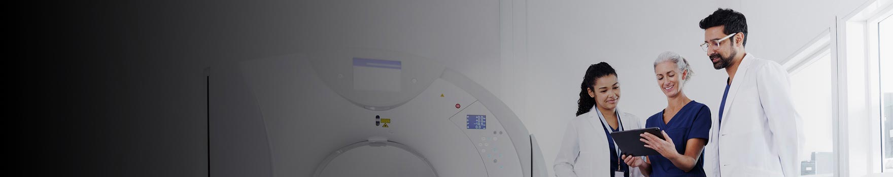 nurse talking to doctor and technician in an MRI exam room