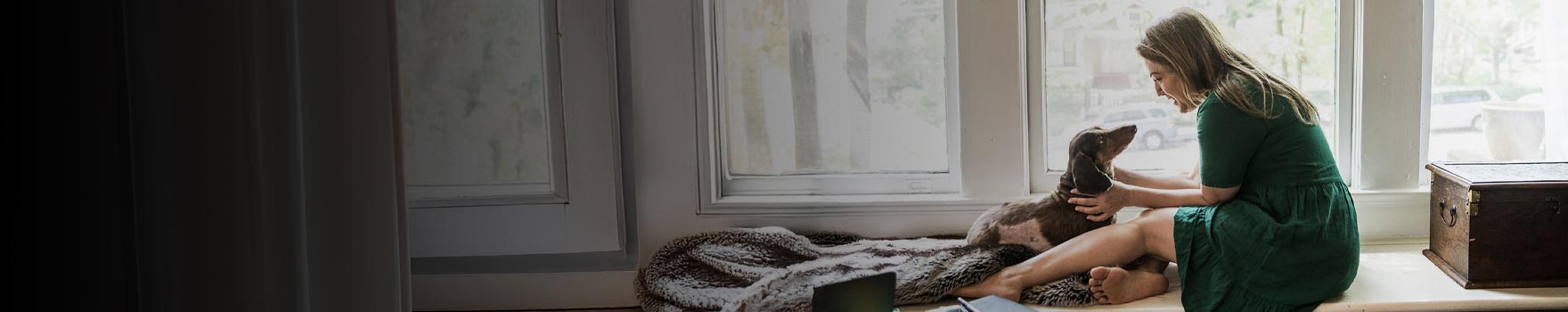 woman talking to her dog on the floor