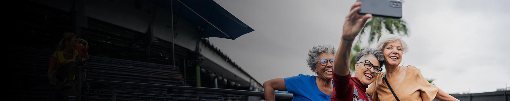 three older women taking a selfie outdoors
