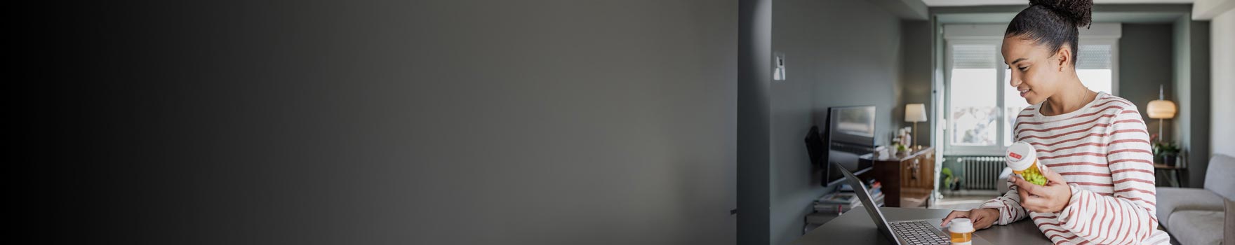 Woman looking at her prescription bottle