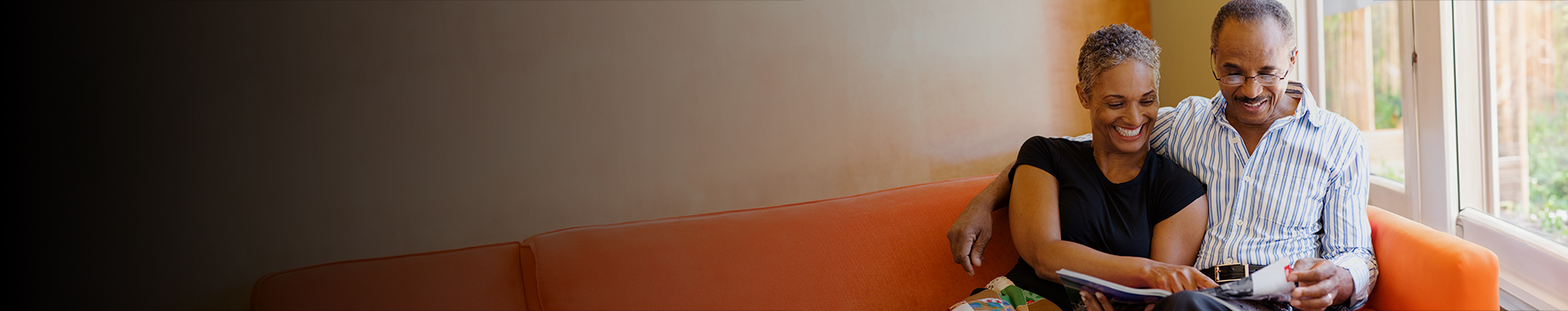 Man and woman reading a magazine