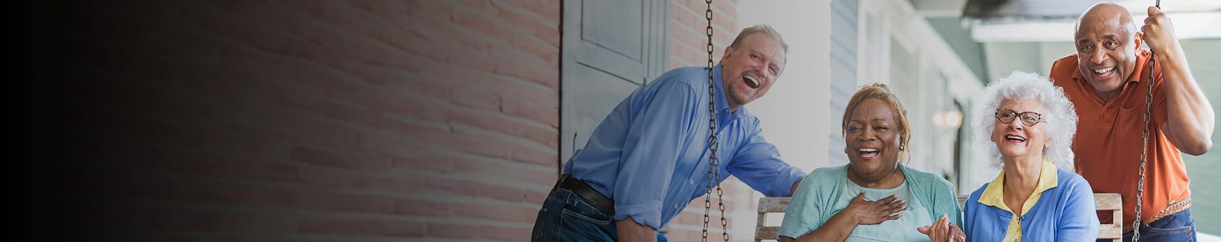 People smiling by a swing