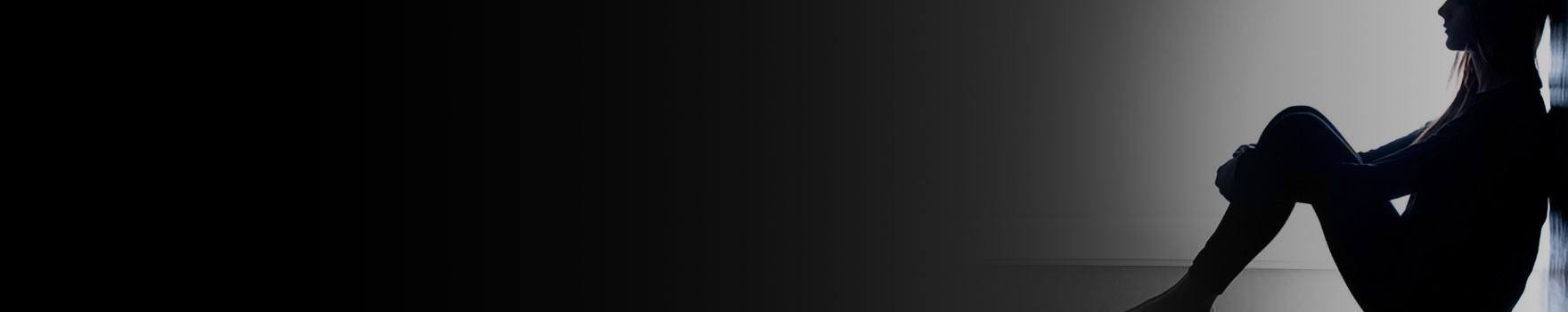 Woman sitting against the wall