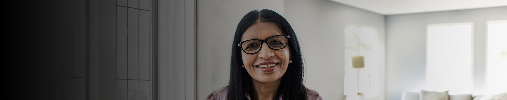 woman with large glasses smiling